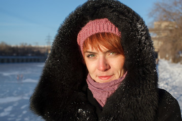 Girl in the hood for a walk in winter