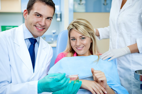 dentist explaining a female patient denture work