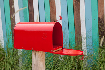 Red mail box on wooden wall