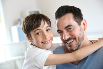 Obraz premium Portrait of father and son relaxing at home