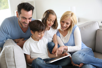 Family websurfing on internet with tablet