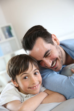 Portrait of father and son relaxing at home