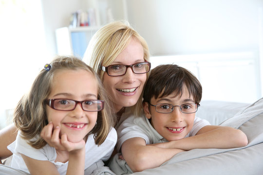Woman and children with eyeglasses on