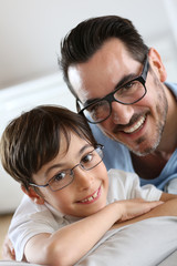 Portrait of young boy with daddy with eyeglasses on
