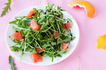 Tasty salad with arugula and grapefruit