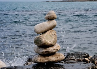 Stones in balance on the rocks of the sea