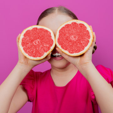 Grapefruit - a young girl with grapefruits - diet concept