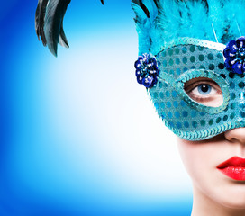 Beautiful woman in blue carnival mask