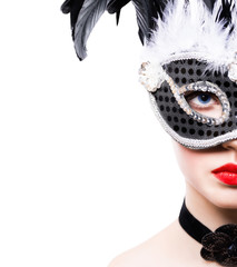 Beautiful young woman in black carnival mask
