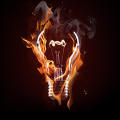 light bulb in fire on black background