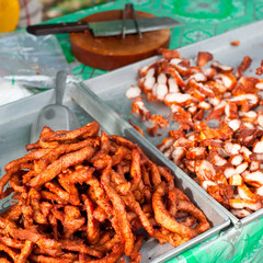 Traditional Thai food at market. Roasted spicy pork