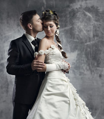 Wedding couple, bride and groom over gray grunge background