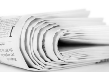 Stack of newspapers on white background
