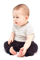 Naklejka premium Thoughtful child sits and looks aside