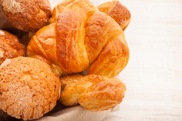 basket of pastries with muffins, croissants