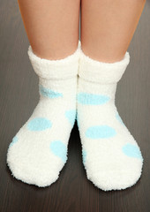 Legs female in socks with polka dots on laminate floor