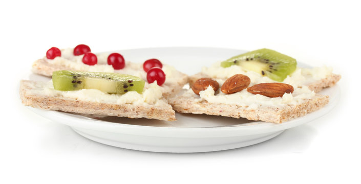 Tasty canapes with cheese, kiwi and cranberry, almond,