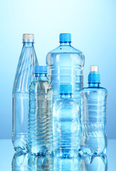 Different water bottles on blue background