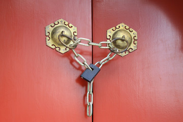 The copper knocker on red door in the Zhengjue temple in Old sum