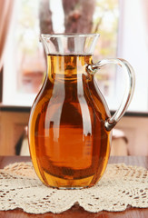 Apple juice in pitcher on table in room