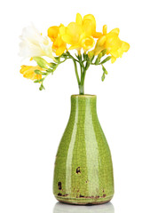 Beautiful bouquet of freesia in yellow vase