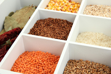 Assortment of cereals in white wooden box close up
