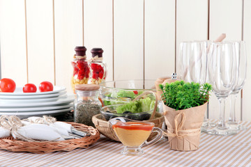 Table setting on checkered tablecloth on wooden background