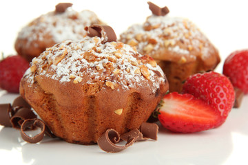 Tasty muffin cakes with strawberries and chocolate, isolated