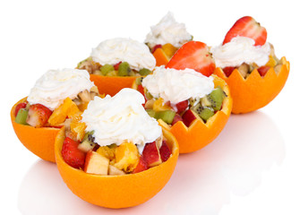 Fruit salad in hollowed-out orange isolated on white