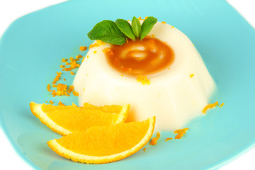 Panna Cotta with orange zest and caramel sauce, isolated
