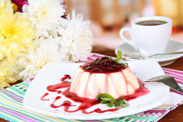 Panna Cotta with raspberry sauce, on bright background