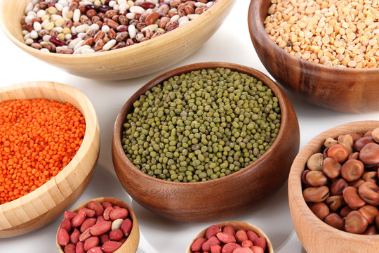 Different kinds of beans in bowls close-up