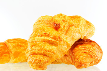 Fresh and tasty croissant over white background