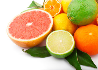 Fresh citrus fruits whole and half with green leaves, food