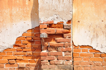 Red clay stained on the white exposed brick concrete wall with p