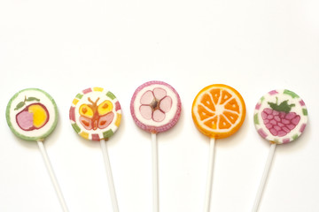 Colorful candy lollipops on white background