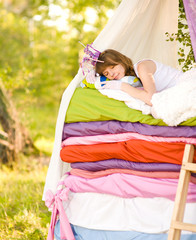 the girl lies on a bed. the fairy tale "the princess on a pea" © Ermolaev Alexandr