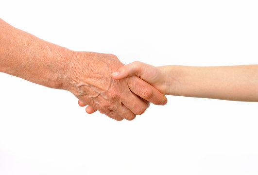 Generations - grandmother and grandchild handshake