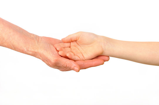 A child puts his hand into the palm of an old woman