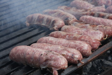 sausage meat and steak in a barbecue in the garden