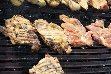 thighs and wings and chicken breasts cooked in a giant barbecue