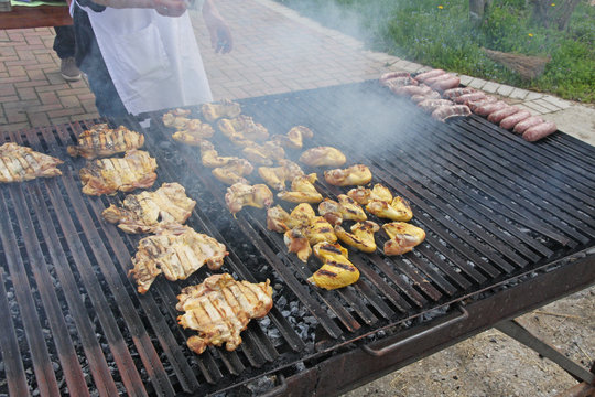 restaurant cook while cooking chicken breasts cooked in a barbec