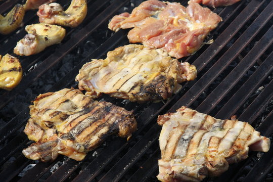 thighs and chicken breasts cooked in a giant barbecue in the gar