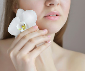 Beautiful woman with white orchid