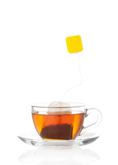 Hot tea in transparent glass cup with label