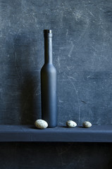 black still-life with bottle and bird eggs - 51224760