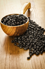 Black beans on wooden background
