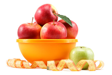 Fresh apples in a bowl and measuring tape isolated on white back