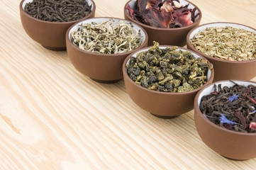 Assortment of dry tea in ceramic bowls