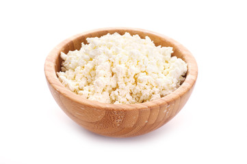 wooden bowl with cottage cheese over white background